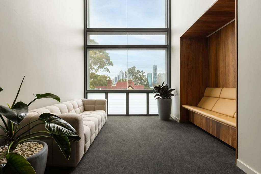 Breakout space on level 2, with a lounge to the left hand side and seating on the right. Straight ahead is a south view of the Centre overlooking Kirribilli Ave.