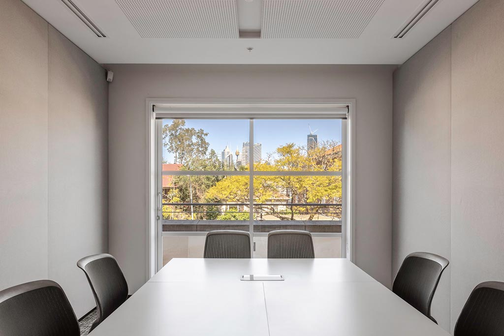 Syndicate room containing table and 6 chairs and a view south of the Centre onto Kirribilli Avenue.